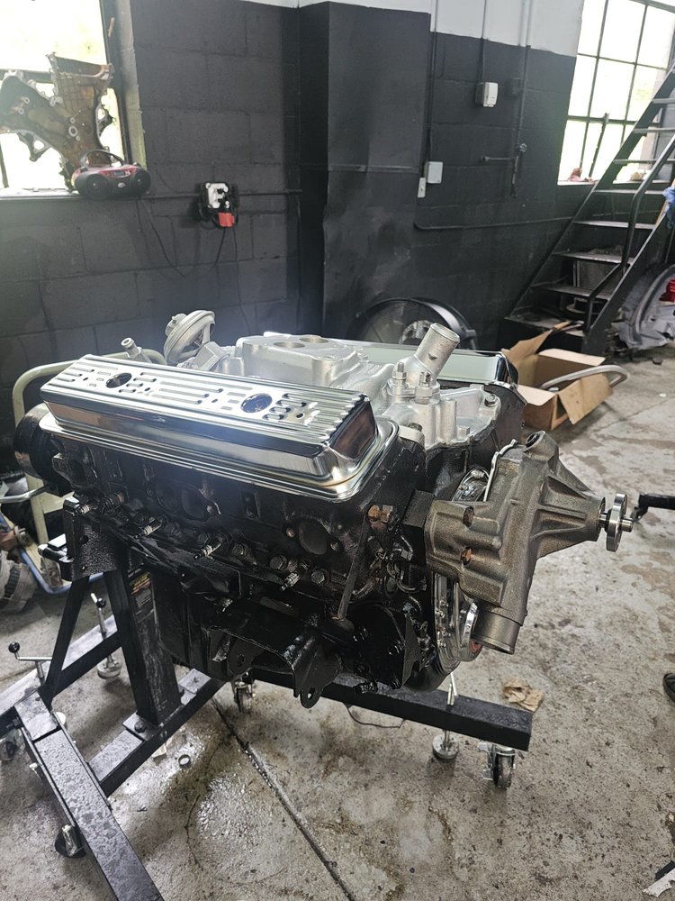 Rebuilt engine with new valve covers on a stand