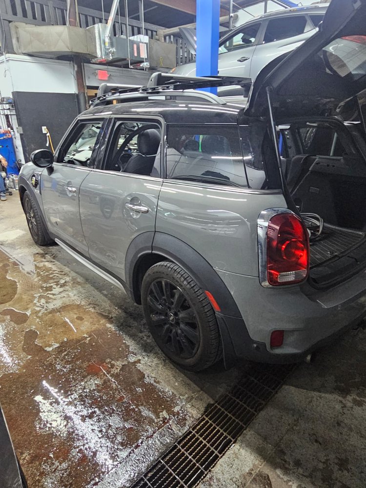 Compact SUV in the bay for repair, hatch open