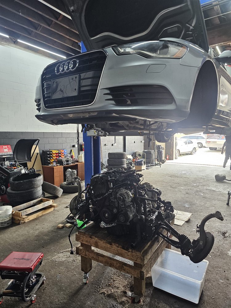 Audi sedan raised on a lift over a removed engine