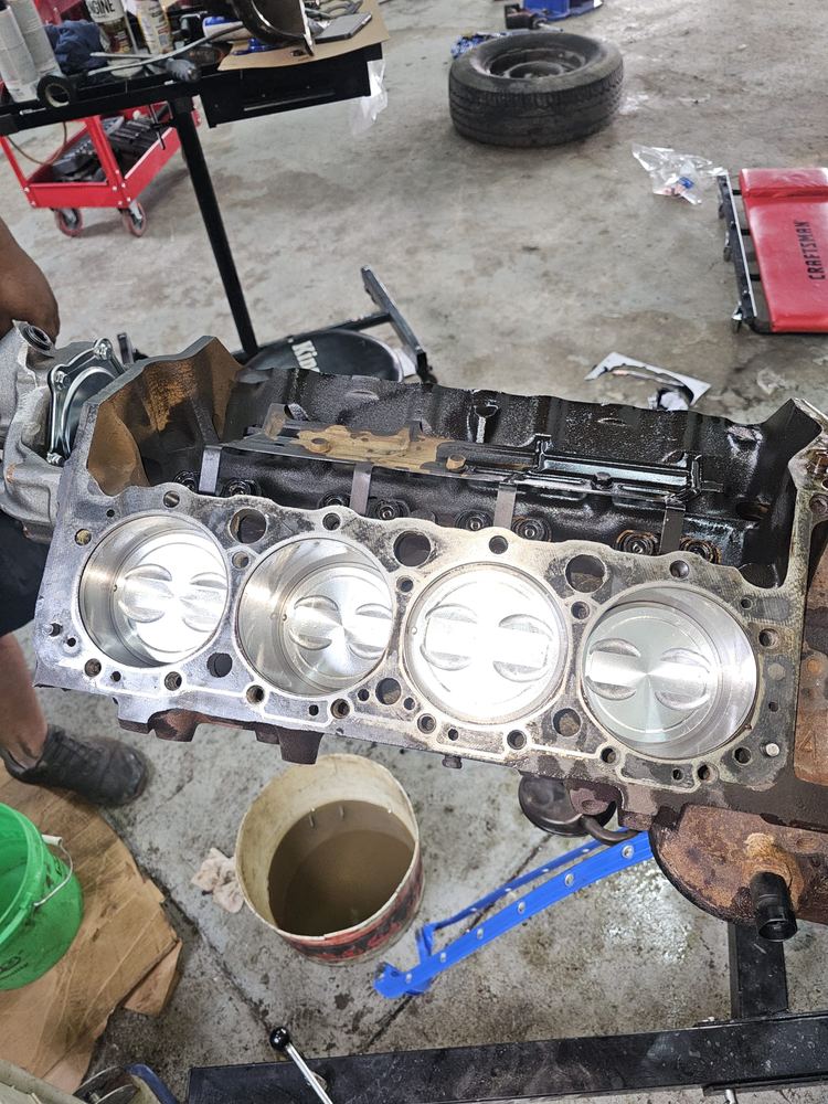 Engine block with pistons installed during engine repair